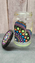 Colorful polka dot objects glass jar on a wooden surface